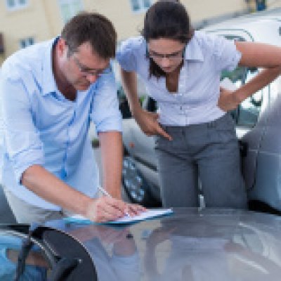 Man and woman filling out car accident report